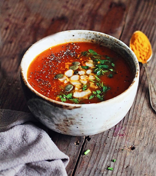 Detoxikační rajčatová polévka s kurkumou a bylinkami v keramické misce